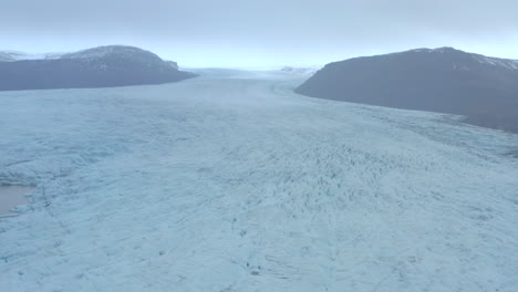 slow descending aerial shot over huge glacier