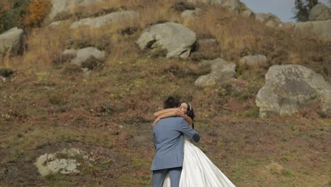 Groom-with-bride-near-mountain-hills.-Wedding-couple.-Happy-family-in-love