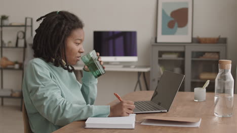 female african student doing homework