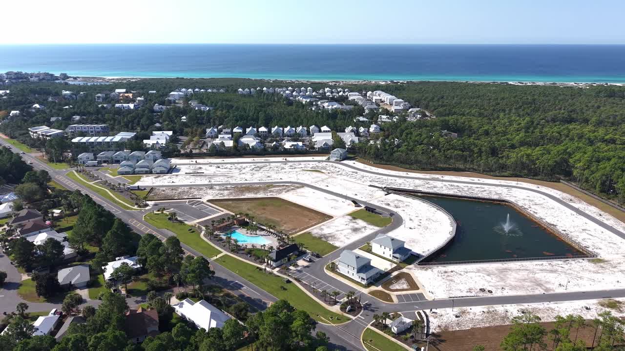 Dynamic drone fly over the new residential community for luxury real estates at Dune Allen Beach construction areas, 30A, Florida, USA