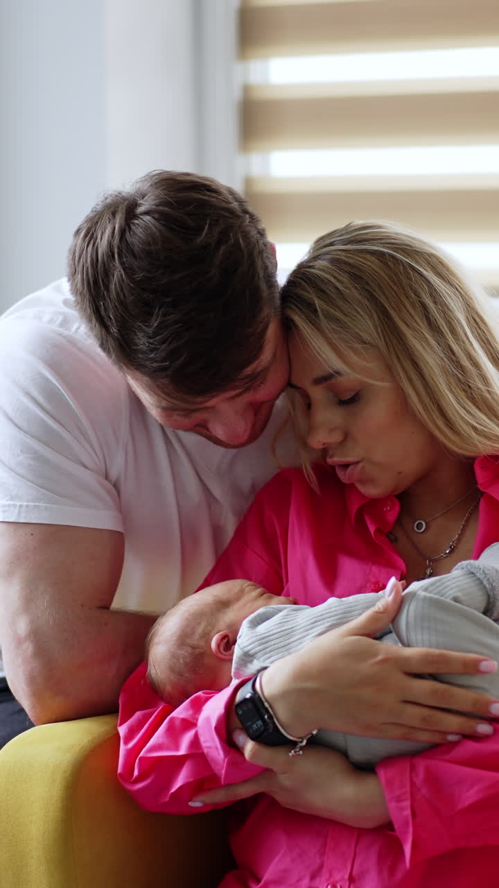 Parents lovingly holding a newborn baby
