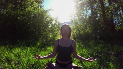 woman practicing yoga in the grassland 4k