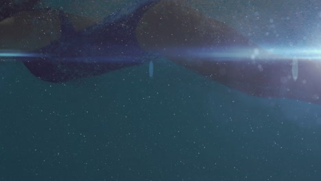 animation of woman swimming with glowing blue light moving in the foreground
