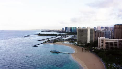 drone shot approaching oahu's rainbow tower and ala wai boat harbor