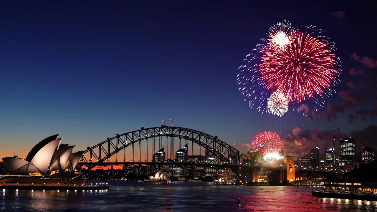 Aerial video captures vibrant fireworks over Sydney Harbour Bridge at dusk, showcasing the Opera