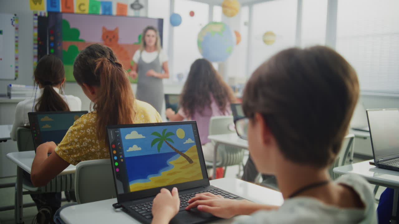 Teacher Educating Young Students Elementary School Children Drawing Pictures on Laptops