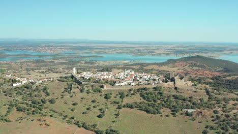 paradisiacal monsaraz castle with turquoise lake in iberian peninsula