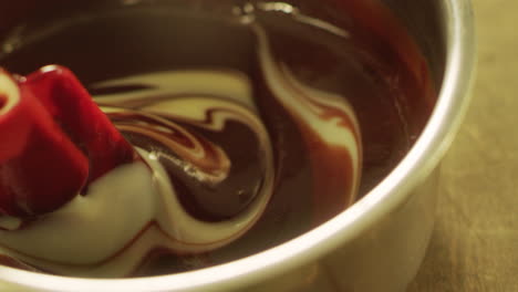 Mixing-dark-and-white-chocolate-with-spatula-in-slow-motion.