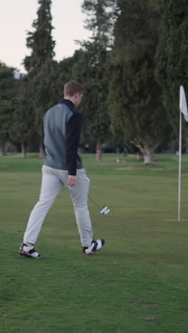 Golfer walking on golf course