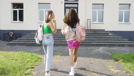 two friends talking outside the high school