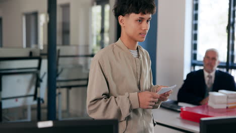 young man giving a presentation in an office