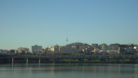 scenic view of the seoul city skyline, hangang river and the yongsan tower on with a clear blue sky