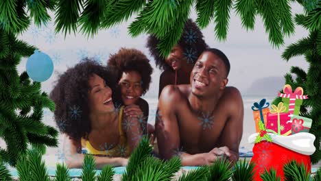 animation of fir tree frame and snowflakes over happy african americna family on beach