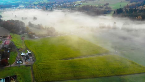 flight over valley green valley with morning mist and a small rural village