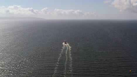 aerial view of a boat traversing the open sea