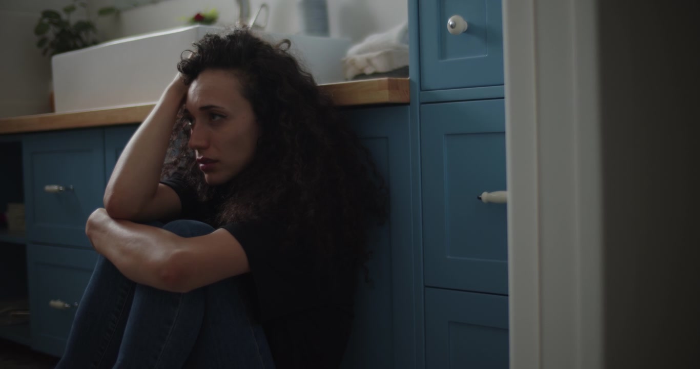 Depressed girl sitting on the floor