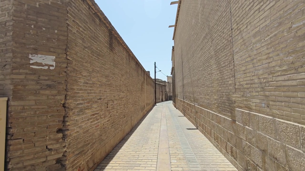 Narrow Alleyway Between Old Brick Walls in Historic City