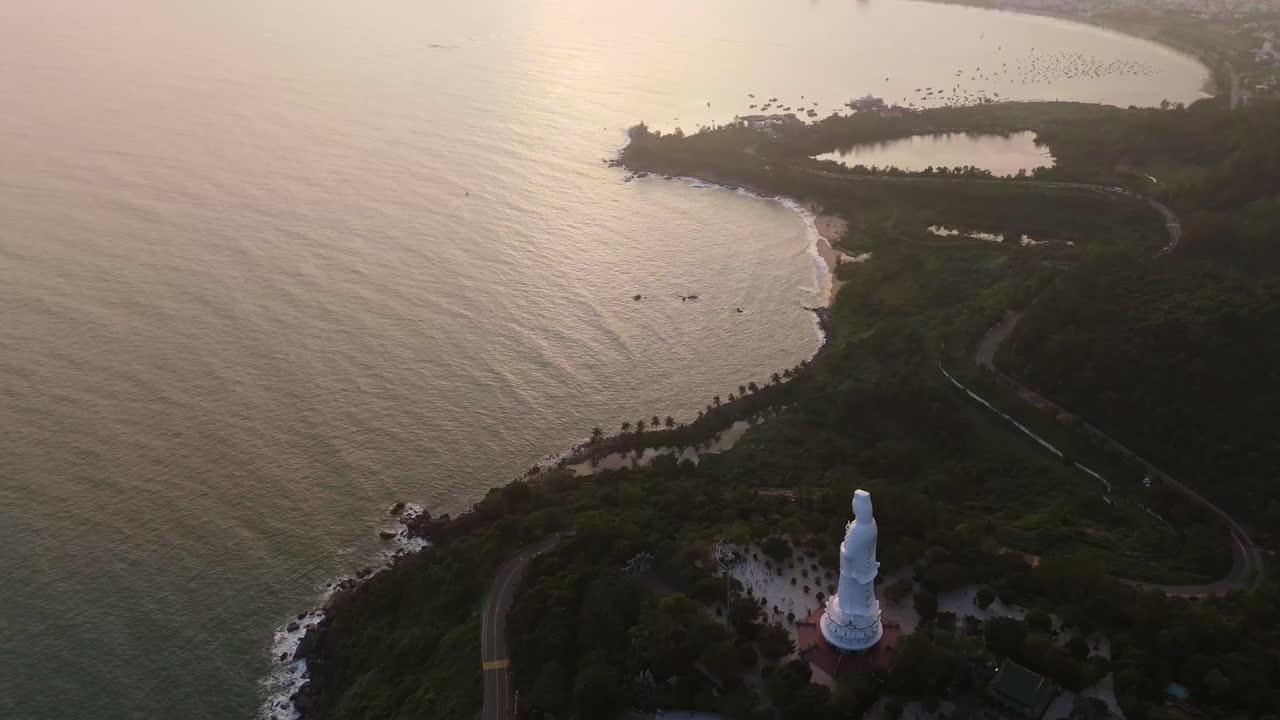 Aerial sunset Panoramic over the distant Da Nang city skyline and coastline, viewed from the Son Tra Peninsula