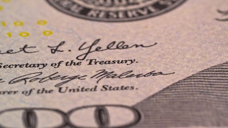 Details on a US one hundred dollar bill with signatures of officials
