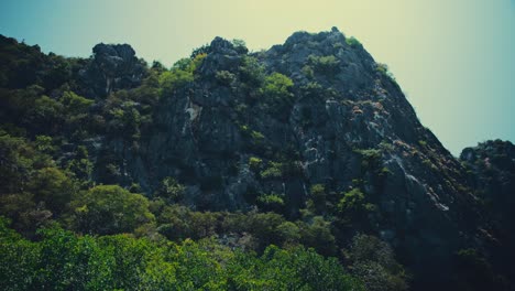 Looking-up-at-a-limestone-hill-while-sailing-past-on-a-boat