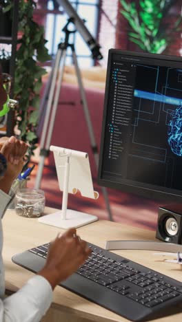Vertical video IT expert doing ecstatic fist pump after successful checkup on AI systems