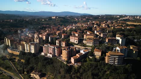 forward drone flight over apartment buildings in siena, italy