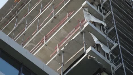 slow motion detail shot of a building under works with the wind moving a plastic