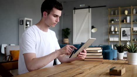 online shopping on tablet by man sitting at wrok