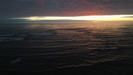 Rotating-Establishing-Aerial-Drone-Shot-Over-Sea-at-Stunning-Sunrise-in-North-Yorkshire-at-Low-Tide-UK