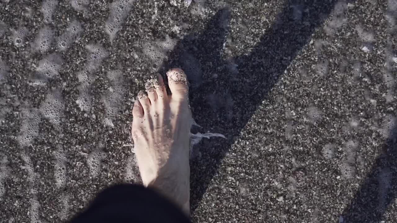 Foot on a sandy beach