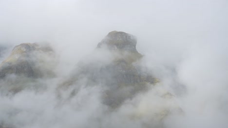 rugged mountains scenery in clouds, rocky himalayas mountain landscape seen through clouds moving through the mountains in nepal