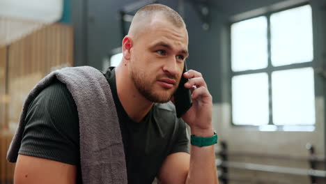 man talking on phone in gym