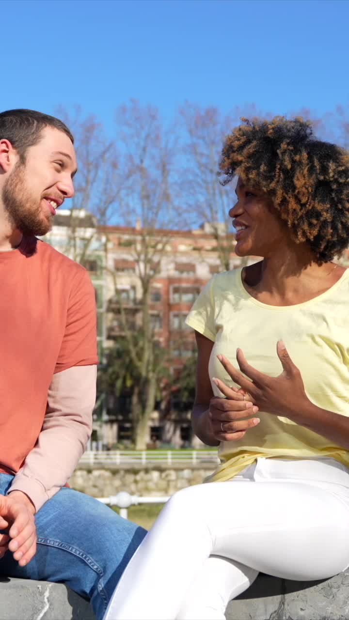 People smiling and talking outdoors