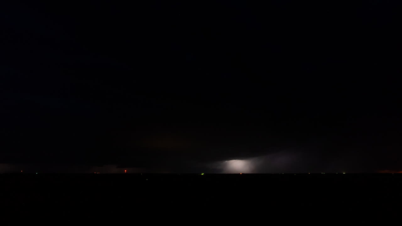 Lightning bolts flash through a storm cloud time lapse