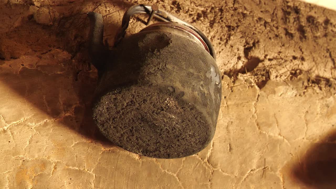 Old pot hanging in the wall of a poor house in Peru. Wall is made of mud. Footage representing poverty and scarcity