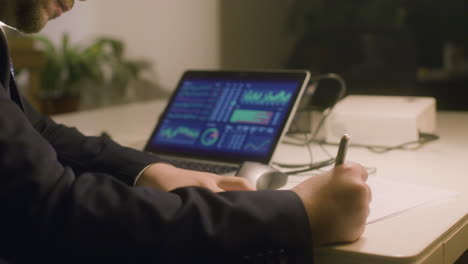 caucasian bearded man working in office while typing on laptop