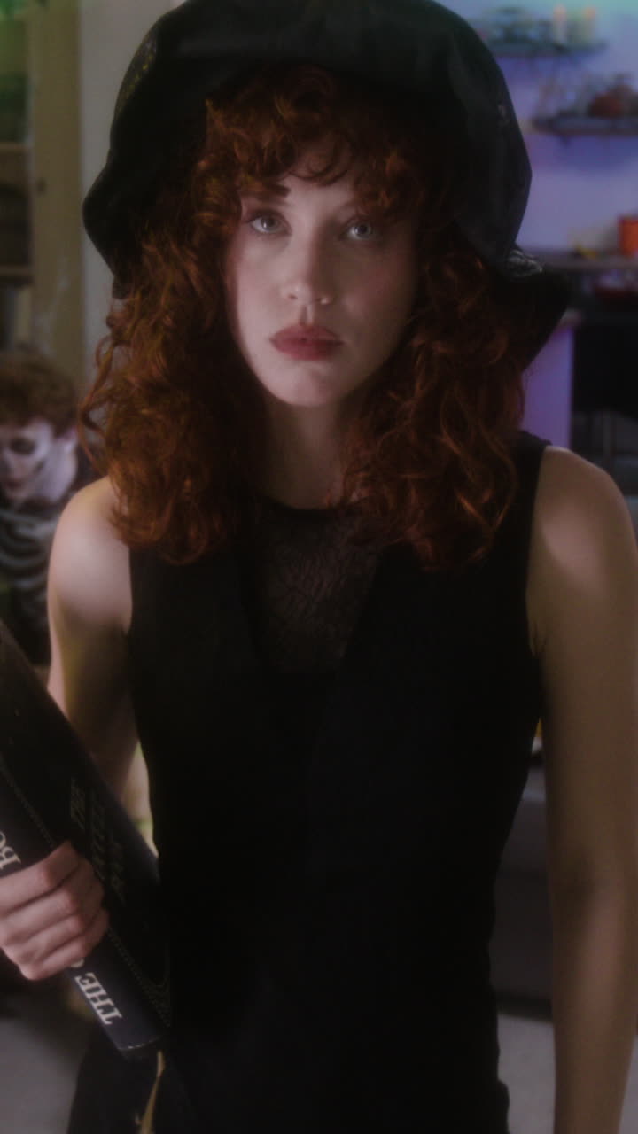 Woman in Witch Costume Reading a Book