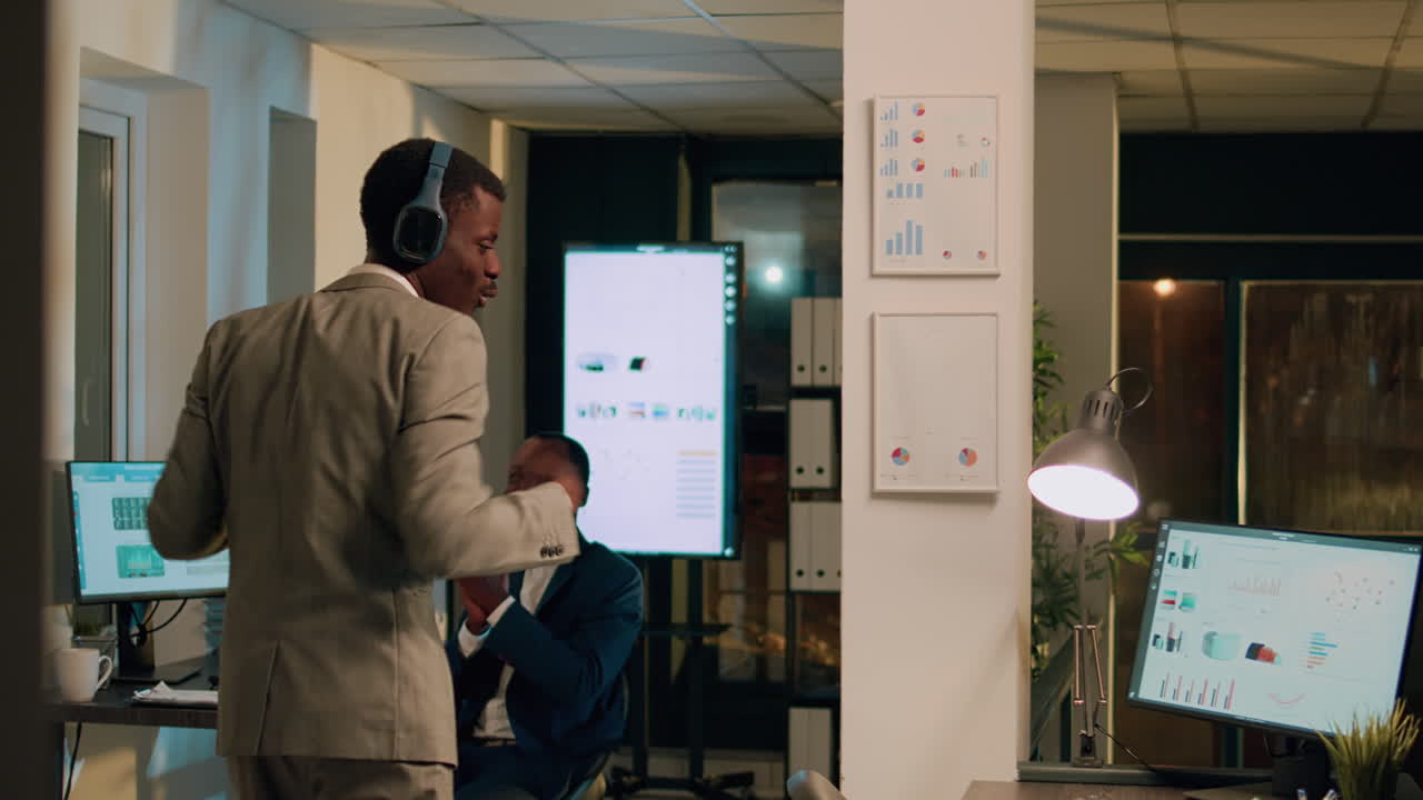 Man listening to music and dancing in the office