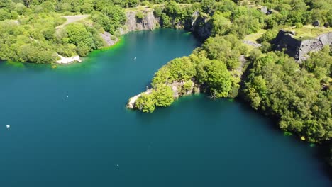 aerial view dorothea slate mining quarry forest in snowdonia valley with gorgeous sunny blue lake