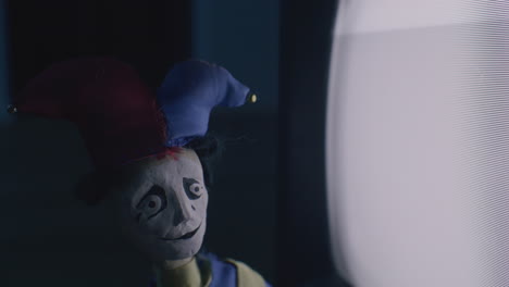 jester puppet in front of a vintage tv