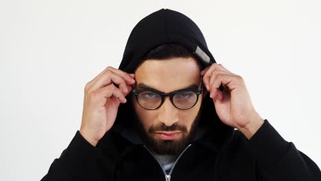 Man-in-hoodie-wearing-spectacles-against-white-background-4k