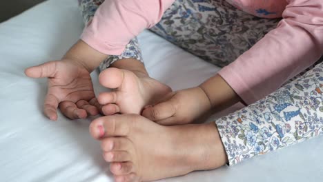 baby playing with her feet