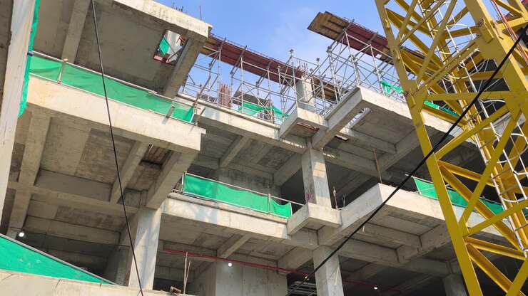 Low angle shot of a reinforced concrete cantilever beam supporting a floor slab. Structural view within an active modern building construction site.
