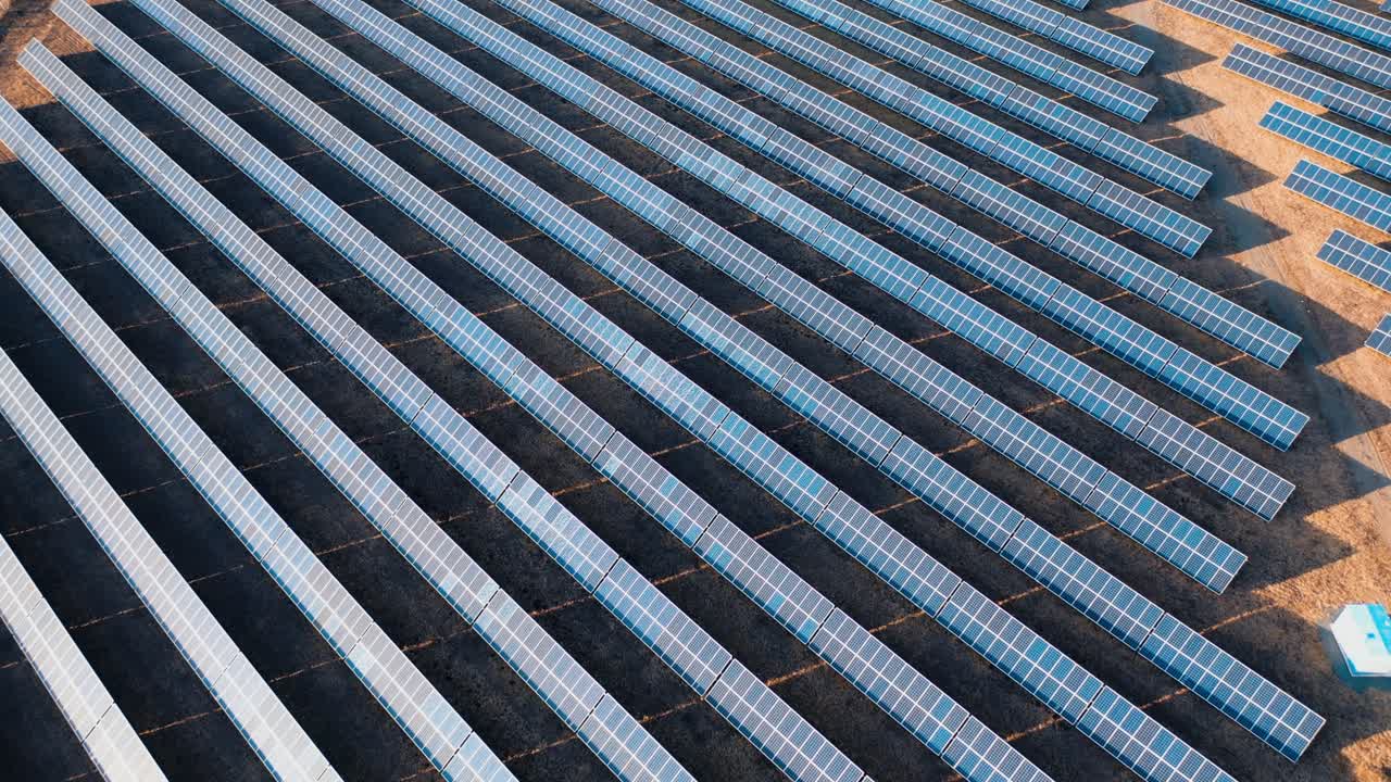 Aerial view of rows of solar panels in a field. Green energy landscape electrical power ecology innovation nature environment