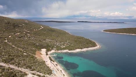 meandering coastal road along adriatic sea, uvala mrtvaska, cres island, croatia