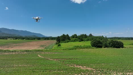 Flying drone equipped with multispectral sensors capturing agricultural landscape