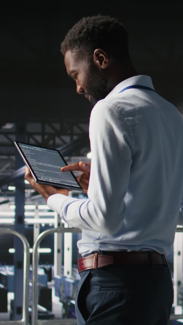 Vertical video Data center programmer checking lines of code next to colleague