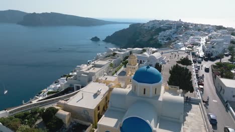 feel the rush of adrenaline as you dive from cliffs into the crystalline waters of santorini's renowned red beach, all from your drone's vantage point