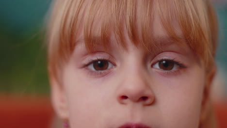 Portrait-Young-Child-Girl-Kid-Looking-at-Camera-Eyes-Close-up-Macro-Looking-To-Camera,-Indoors