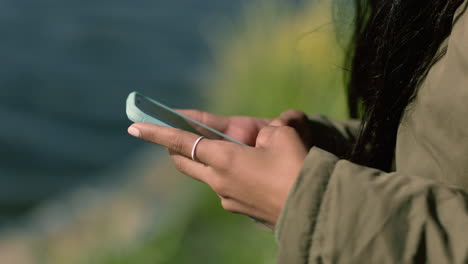 close-up-woman-hands-using-smartphone-texting-sending-messages-chatting-online-social-media-sharing-digital-communication-on-mobile-phone-in-seaside